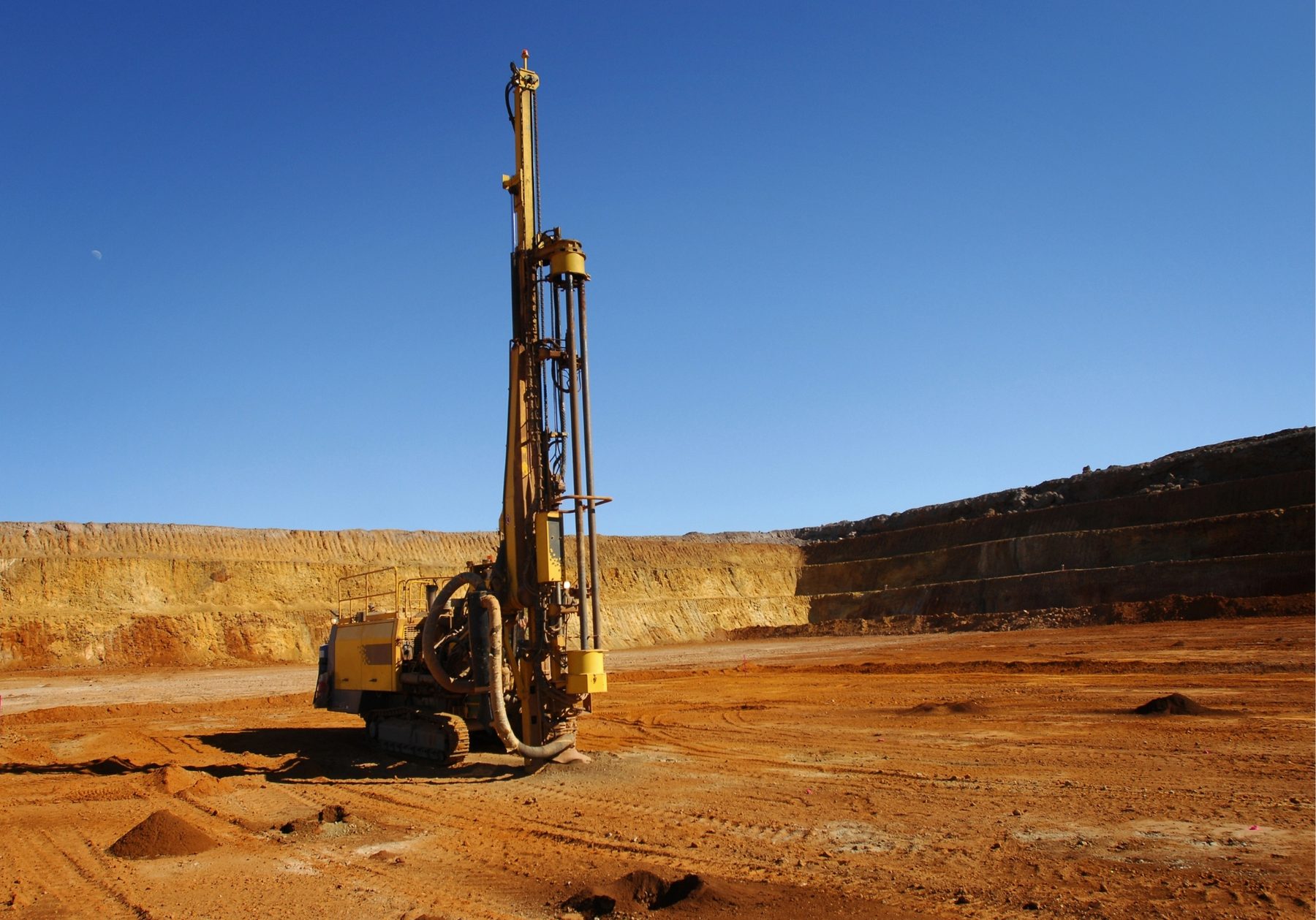 Top-hammer drill rig operating on an East African quarry site